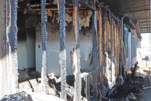 (THOMAS WALLNER | THE GRAHAM LEADER) A portion of a mobile home that caught on fire with hay early Monday, Dec. 3 at the Red Orchard Animal Rescue Foundation in Loving. The rescue is looking for support after the fire destroyed supplies and hay for the animals at the rescue.