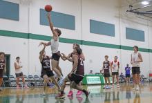 (ALEX KIELAR | THE GRAHAM LEADER) Star player of the Steers, Cooper Corley, attempts a layup against the Hawley Bulldogs in the final week of the summer basketball league Tuesday, June 24. Corley continued his strong offensive production during the summer league as the leading scorer.