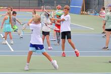 (ALEX HAVARDANSKY | THE GRAHAM LEADER) Steers and Lady Blues campers practice their swing form during Graham tennis camp Tuesday, June 10. Younger campers took the morning sessions while older campers took the afternoon sessions.