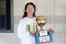 (ALEX HAVARDANSKY | THE GRAHAM LEADER) Marci Faulk stands with her gold ball celebrating reaching the 500th career win mark. Faulk has served as the head coach for both the Graham Lady Blues and Bryson Cowgirls volleyball teams throughout her career. 