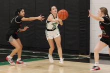 (ALEX HAVARDANSKY | THE GRAHAM LEADER) Rae’Lynn Bennett passes the ball to a teammate Thursday, Dec. 18 against the Mineral Wells Lady Rams. The Ladycats will pick things up Tuesday, Dec. 30 against Baird on the road. 
