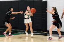 (ALEX HAVARDANSKY | THE GRAHAM LEADER)  Rae’Lynn Bennett passes the ball to a teammate Thursday, Dec. 18 against the Mineral Wells Lady Rams. The Newcastle Ladycats played a late-week matchup against the Archer City Lady Cats and made the hometown crowd happy, coming away with the victory by a final score of 43-30. 