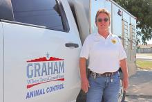 (THOMAS WALLNER | THE GRAHAM LEADER) Animal Control Officer Kim Shawver poses in front of her patrol vehicle. Shawver will be closing out 40 years of service in the position when she retires Thursday, Aug. 29.