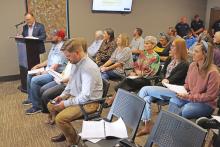 (THOMAS WALLNER | THE GRAHAM LEADER) City Manager Eric Garretty (at podium) gives a presentation on the upcoming fiscal year budget before a public hearing Thursday, Aug. 15. After a third reading Thursday, Aug. 29 the Graham City Council adopted the budget.