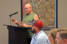 (THOMAS WALLNER | THE GRAHAM LEADER) Greg Bonzelaar speaks at the public hearing Thursday, Aug. 15 regarding the increases to sewer connection charges, water tapping fees and wastewater and water service charges. Bonzelaar had concerns about the cost for retaining engineering services.