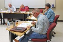 (THOMAS WALLNER | THE GRAHAM LEADER) Members of the Graham ISD Board of Trustees look over the proposed budget Wednesday, Aug. 28 after a public hearing was held for the budget and tax rate. Shown from left to right are Board President Chris Blanton, Superintendent Sonny Cruse, Jason Smith (front) and Brandon Joy.
