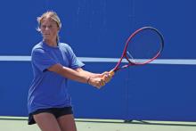 (ALEX HAVARDANSKY | THE GRAHAM LEADER) Kline Krupp lines up to take a swing at a ball Wednesday, Aug. 6. The doubles team of Jade Dospapas and Krupp got the lone win for the Lady Blues doubles team against Azle.
