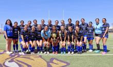 (THOMAS WALLNER | THE GRAHAM LEADER) The Lady Blues pose with their area championship trophy after their 1-0 win Tuesday, March 24 over the Lubbock-Cooper Liberty Lady Patriots at Sandifer Stadium in Abilene. The team advanced to the regional semifinal round held Friday, March 27.