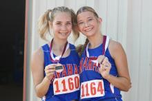 (KYLIE BAILEY | THE GRAHAM LEADER) Maddison Bishop (left) and Taylan Locker came home with medals after the Battle of the Back 40 in Poolville. Locker finished 13th in the while Bishop finished 16th at the event Wednesday, Sept. 17. 
