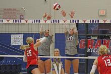 (ALEX HAVARDANSKY | THE GRAHAM LEADER) Madison Cauble and Emily Hughes team up for a block attempt Tuesday, Aug. 19 in their match against the Lady Indians. Unfortunately for Graham, the Lady Blues lost their home opener in three sets.