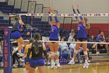 (ALEX HAVARDANKSY | THE GRAHAM LEADER) Madison Cauble, left, and Emily Hughes, right, go up for a block Friday, Sept. 12. The Lady Blues defeated the Lady Leopards in three sets during the game. 