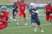 (ALEX HAVARDANSKY | THE GRAHAM LEADER) Mason Milton (12) runs down a red receiver for a tackle Saturday, June 7. Milton had a highlight play of the game with a big fourth down stop to force a turnover on downs.