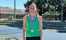 (NEWCASTLE ISD | CONTRIBUTED PHOTO) Newcastle’s Mattie Dollar with her medal for being the girls runner up in the regional tennis tournament in North Richland Hills. For qualifying for the championship match, Dollar punched her ticket to Dodd City for the state tournament Thursday, May 15. 