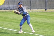 (MIKE WILLIAMS | THE GRAHAM LEADER) Jaysea Rickels makes a throw from left field during the first inning of the Lady Blues’ 8-0 win at home Tuesday, March 14 over Springtown.