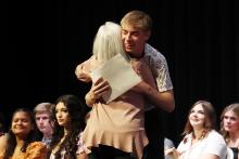 (THOMAS WALLNER | THE GRAHAM LEADER) Jack Page hugs Graham High School Theatre Teacher Kay Berru during the GHS Scholarship Awards Ceremony held Monday, April 27 at Graham Memorial Auditorium.