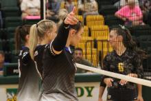 (ALEX HAVARDANSKY | THE GRAHAM LEADER) Treyton McCullough, front, sets up defensively in the front row for the Lady Blues in their matchup Tuesday, Aug. 26. McCullough returned to the court on this date while also picking up her first point on the season.