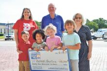 (ARCHIVE PHOTO | THE GRAHAM LEADER) Graham Area United Way Executive Director Susie Cerecedez (at right) presents a check for $26,000 to Bethel Daycare which was raised during the 2019 GAUW campaign. From left to right are Brandy Dumith (back), Jase Hamm, Emersyn Smiley, Eddy Neal (back), Addi Poole, Cooper Kitchens and Cerecedez.