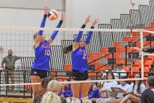 (ALEX HAVARDANSKY | THE GRAHAM LEADER) Emily Hughes (left) and Madison Cauble (right) go up for a block Tuesday, Aug. 12, against the Lady Bulldogs. Cauble had a set clinching block to seal a set three win for the team.