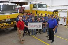 (THOMAS WALLNER | THE GRAHAM LEADER) Members of Salt Creek Volunteer Fire Department are presented a $20,000 check by Oncor Area Manager Gordon Drake as part of an investment in volunteer departments from the Oncor Cares Foundation. The department is one of 26 that will be presented with checks from the foundation.