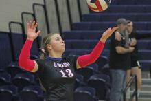 (ALEX HAVARDANKSY | THE GRAHAM LEADER) Ruby Shaffer throws the ball up for a serve attempt Tuesday, Oct. 7, against the Mineral Wells Lady Rams. The team started the night off right with their three set win over the Mineral Wells Lady Rams.