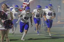 (ALEX HAVARDANSKY | THE GRAHAM LEADER) The Steers ran out of the tunnel for the second half of their matchup against the Burkburnett Bulldogs. The Steers won their first district matchup Friday, Oct. 10. 