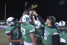 (TC GORDON | THE GRAHAM LEADER) The Newcastle Bobcats lift their bi-district championship trophy above their heads Friday, Nov. 15 after defeating the previously undefeated Spur Bulldogs 74-22.