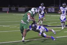 (TC GORDON | THE GRAHAM LEADER) Newcastle’s Keyton Newland stiff arms a Westbrook defender on his way for a touchdown Friday, Nov. 22 during the Bobcats’ hard-fought 98-52 loss in the area round of the playoffs.
