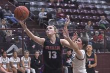 (TC GORDON | THE GRAHAM LEADER) Graham’s Fayth Bryer gets past a defender and lays the ball up as she looks to score in one of the games of the Lady Blues’ tournament run in Bowie this past week.