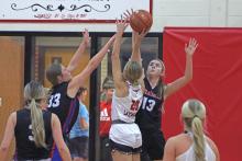 (TC GORDON | THE GRAHAM LEADER) Teammates Briley Randall (33) and Fayth Bryer (13) jump together to try to block a shot from an Eastland player Tuesday, Dec. 3 in Graham’s 60-53 win over the Lady Mavs.