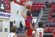 (TC GORDON | THE GRAHAM LEADER) Graham’s Brodie Martin gets past Eastland defenders and makes a layup at the rim Tuesday, Dec. 3 in the team’s 67-51 win over the Mavericks.
