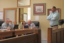 (MADDISON EVANS | THE GRAHAM LEADER) Andrew Bryant (at right), of Goin’ Green Lawn & Landscape, spoke with the Young County Commissioners Court at their meeting Monday, Feb. 13. Bryant is donating landscaping work for the courthouse lawn. 