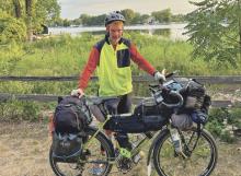 (CONTRIBUTED PHOTO | STEVE HOLMAN) Steve Holman shows off his bike named ‘Hulk’ in Minnesota during his year-and-a-half long bike tour. Holman was born and raised in Graham and began his trip in March 2021. 
