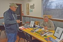 (FILE PHOTO | THE GRAHAM LEADER) Author Greg Coker signs an autograph for his book ‘Death Waits in the Dark: Six Guns Don’t Miss,’ in 2021 at Brother’s Smokehouse. Coker will be one of over 20 authors that is attending the inaugural Young County Book Festival from 10 a.m. to 1 p.m. Saturday, Dec. 10 at the Library of Graham.