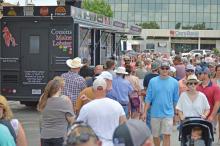 (FILE PHOTO | THE GRAHAM LEADER) Visitors to the 2022 Food Truck Championship of Texas on the Graham downtown square line up at the Cousins Maine Lobster food truck Saturday, June 4. The Graham City Council has been in discussions regarding designating a food truck park for local food trucks.