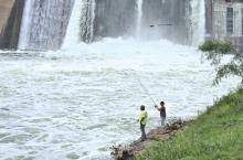 (RON EISELE | CONTRIBUTED PHOTO) Fishermen cast lines at the base of the Possum Kingdom dam which has been opening its gates recently due to a large amount of rainfall in the area.