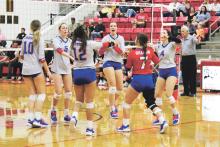 (MIKE WILLIAMS | THE GRAHAM LEADER) The Lady Blues (pictured celebrating after earning a point in Mineral Wells) earned a spot in the playoffs with their Friday, Oct. 14 win in Brownwood over the Lady Lions. The Lady Blues host Christ Academy at 4 p.m. Friday, Oct. 21.