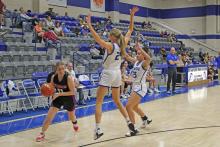 (MIKE WILLIAMS | THE GRAHAM LEADER) Maddie Franklin attempts to dribble out of a double team during the Lady Blues’ 44-22 loss at Stamford Tuesday Nov. 29. Franklin finished the game with four points.