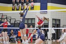 (MIKE WILLIAMS | THE GRAHAM LEADER) Tara Dawson attempts to swing a ball over the Honeybees’ block during the first set of the junior varsity Lady Blues’ 25-17, 25-17 loss during Tuesday’s season finale loss. Dawson finished the match with two kills.