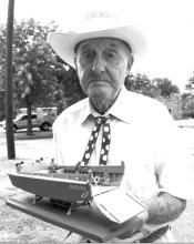 Samuel Odis Lewis holds a model Higgins boat made and given to him by Graham Police Chief Tony Widner in this photo from 2014. The model was created to honor Lewis’ service during the July 21, 1944, invasion of Guam during World War II. Lewis was a coxswain who ran a crew of four on his own Higgins boat during the invasion. 