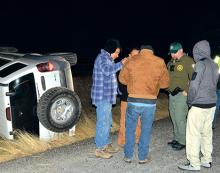 Deputy Devin Wright talks to the driver and passengers of a Jeep which rolled over on White Rose Road Saturday while Graham Leader reporter Thomas Wallner was riding along with Wright. The accident had no reported injuries.  Leader photo by Thomas Wallner