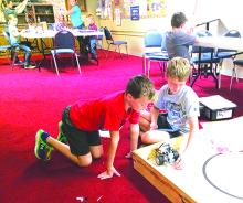 Max Smith (left) and Nate Hutson do a test run of their Lego Mindstorms robot which they constructed for the Texas Computer Education Association State Mindstorms Robotics Challenge. Courtesy photo