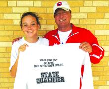 Graham Lady Blues varsity cross country runner Khloe Morris poses alongside Lady Blues head coach Ky Graham with a state qualifier shirt after Morris finished 12th this past Saturday at the regional cross country meet giving her a chance to run on Nov. 12 at Old Settlers Park in Round Rock at the state meet. Courtesy Photo