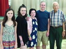 Honored for traveling the greatest distance to the 64th annual Rocky Mound Reunion were Michael and Debby Anderson, with their daughters Katie and Claire, who attended from Prosper. With them, far right, is Monroe Robertson, who was honored for being Most Senior Gentleman in attendance.