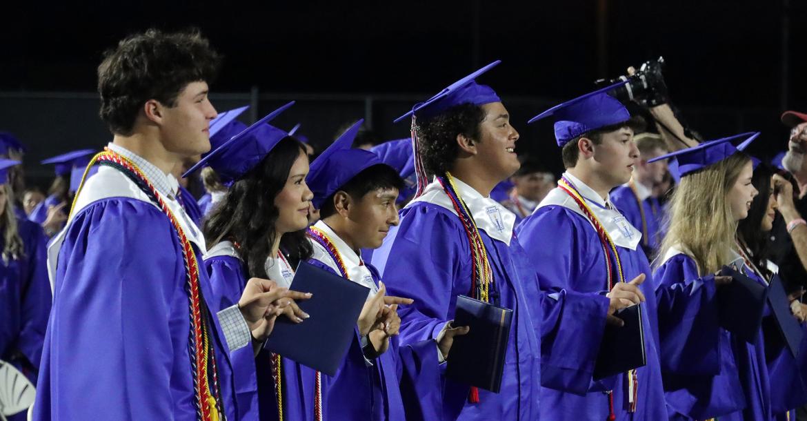 (THOMAS WALLNER | THE GRAHAM LEADER) Graham High School graduates lock hands as they sing the school song at the conclusion of the graduation ceremony held Friday, May 22. 