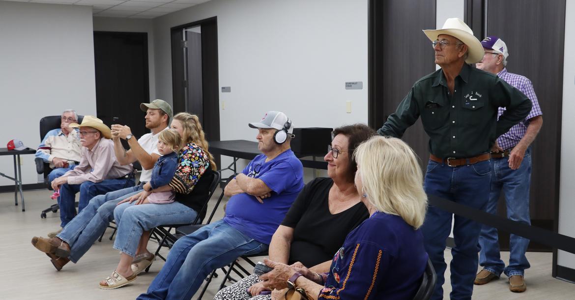 (THOMAS WALLNER | THE GRAHAM LEADER) Visitors at the Young County Annex take pictures of the results as they are displayed by the Young County Elections Administrator following the conclusion of voting Tuesday, May 26 in the primary runoff election.